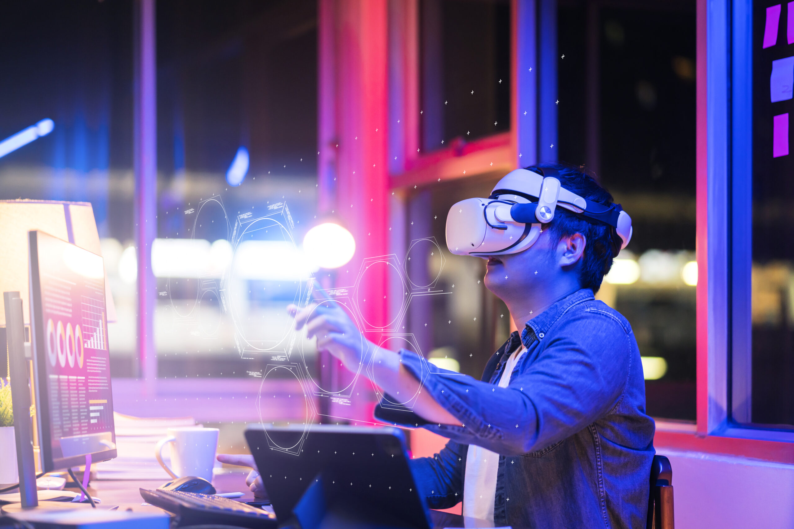 asian young male wearing wearable goggle headset virtual online meeting digital space working with 3d augmented dimension at home,cyber virtual working with virtual vr goggle and pc desktop device